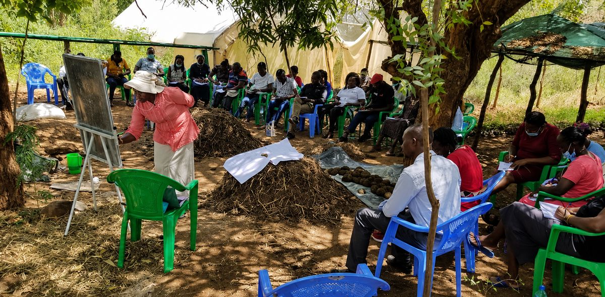 Sylvia Kuria leads an agroecology training for farmers seated under trees